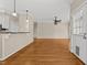Open living room with hardwood floors and access to kitchen, hallway, and back patio at 608 Driftwood Dr, Gibsonville, NC 27249