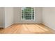 Living Room with hardwood floors and lots of natural light from the large window at 608 Driftwood Dr, Gibsonville, NC 27249