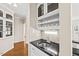Stylish wet bar features a granite countertop, wine rack, and a built-in sink at 608 Driftwood Dr, Gibsonville, NC 27249