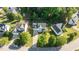 Aerial view of white home showcasing the lawn, driveway, and mature trees at 612 Lakeview Ave, Wake Forest, NC 27587