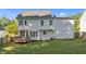 White home's backyard features a wood deck, large lawn, and mature trees at 612 Lakeview Ave, Wake Forest, NC 27587