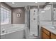 Bathroom featuring glass-enclosed shower and garden tub with tiled surround at 612 Lakeview Ave, Wake Forest, NC 27587
