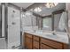 Bathroom featuring double sink vanity, glass-enclosed shower, and white tile at 612 Lakeview Ave, Wake Forest, NC 27587