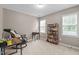 Neutral bedroom with chair, desk, book shelf, and two windows with blinds at 612 Lakeview Ave, Wake Forest, NC 27587