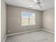 Neutral bedroom with light carpet, ceiling fan, and large window with blinds at 612 Lakeview Ave, Wake Forest, NC 27587