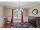 Inviting dining room features a floral rug, large window, stylish chandelier, and classic wainscoting at 612 Lakeview Ave, Wake Forest, NC 27587