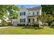 Well-maintained two-story home with black shutters, a quaint front porch, and a circular window accenting the facade at 612 Lakeview Ave, Wake Forest, NC 27587