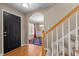 Welcoming foyer with hardwood floors, staircase, and an archway leading to the elegant dining room at 612 Lakeview Ave, Wake Forest, NC 27587
