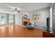 Bright living room featuring a cozy fireplace, hardwood floors, a ceiling fan, and French doors to the exterior at 612 Lakeview Ave, Wake Forest, NC 27587