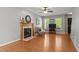 Comfortable living room featuring a fireplace, hardwood floors, natural light, and a ceiling fan at 612 Lakeview Ave, Wake Forest, NC 27587