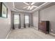 Carpeted bedroom featuring tray ceiling, dual windows, and wooden dresser at 612 Lakeview Ave, Wake Forest, NC 27587