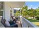 Cozy porch with wicker chairs, plush cushions, and a view of the lush, green lawn and mature trees at 612 Lakeview Ave, Wake Forest, NC 27587