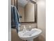 Small powder room featuring pedestal sink and framed mirror at 612 Lakeview Ave, Wake Forest, NC 27587