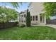 Lush backyard with a screened-in porch, mature trees, and well-maintained lawn, perfect for outdoor activities at 707 Sasser St, Raleigh, NC 27604