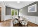 Bright dining room features hardwood floors, white trim, and a large window at 707 Sasser St, Raleigh, NC 27604