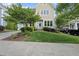 Charming two-story home featuring a well-manicured lawn and a vibrant turquoise front door at 707 Sasser St, Raleigh, NC 27604