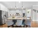 Well-lit kitchen with a large island, counter seating, and stainless steel appliances at 707 Sasser St, Raleigh, NC 27604