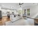 Bright open-concept living room featuring hardwood floors, modern furniture, and a view into the kitchen at 707 Sasser St, Raleigh, NC 27604