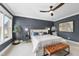 Main bedroom featuring a decorative navy blue accent wall, large windows, and carpeted floors at 707 Sasser St, Raleigh, NC 27604