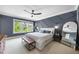 Main bedroom featuring a decorative navy blue accent wall, large windows and carpeted floors at 707 Sasser St, Raleigh, NC 27604