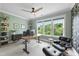 Comfortable home office with stylish furniture, ceiling fan, and windows that provide natural light and backyard views at 707 Sasser St, Raleigh, NC 27604