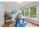Bright home office featuring hardwood floors, neutral walls and large windows with outside views at 707 Sasser St, Raleigh, NC 27604