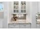 Stylish wet bar featuring granite counters, white cabinets, and a wine rack at 707 Sasser St, Raleigh, NC 27604