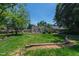 A spacious backyard featuring a well-maintained lawn, mature trees, and a large deck with outdoor furniture perfect for entertaining at 713 E Whitaker Mill Rd, Raleigh, NC 27608