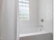 Bright white bathroom showcasing a soaking tub and white subway tile at 713 E Whitaker Mill Rd, Raleigh, NC 27608