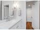 Bathroom featuring a vanity, framed mirror, and hardwood floors at 713 E Whitaker Mill Rd, Raleigh, NC 27608