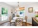 Cozy dining area with a white table, stylish chairs, natural light, and easy access to the outdoor space at 713 E Whitaker Mill Rd, Raleigh, NC 27608