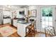 Bright, updated kitchen with white cabinetry, stainless steel appliances, and a convenient breakfast bar with counter seating at 713 E Whitaker Mill Rd, Raleigh, NC 27608