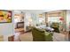 Cozy living room with hardwood floors, white sofa, green accents, and an adjacent foyer with natural light at 713 E Whitaker Mill Rd, Raleigh, NC 27608