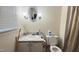 Simple, neutral-toned bathroom with vanity, toilet, and window with blinds at 7312 Ray Rd, Raleigh, NC 27613