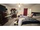 Neutral toned bedroom with ceiling fan, dresser, oval mirror, ironing board, and unmade bed at 7312 Ray Rd, Raleigh, NC 27613
