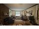 Cozy living room featuring a brick fireplace, a large window, and comfortable seating at 7312 Ray Rd, Raleigh, NC 27613