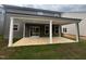 View of the back porch with white columns and sliding door entry at 776 Old Station Pointe, Angier, NC 27501