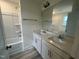Bathroom showcasing double sinks, white cabinets, and modern fixtures next to shower at 776 Old Station Pointe, Angier, NC 27501