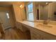 Bathroom with a double vanity, neutral tones, and a window providing natural light at 776 Old Station Pointe, Angier, NC 27501