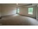Spacious primary bedroom with neutral carpet, trey ceiling and natural light at 776 Old Station Pointe, Angier, NC 27501