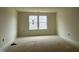 A light filled bedroom with two windows and neutral paint, ready for personalization and decor at 776 Old Station Pointe, Angier, NC 27501