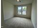 Bright bedroom with neutral carpet and natural light from two large windows at 776 Old Station Pointe, Angier, NC 27501