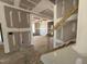 View of unfinished entryway exhibiting staircase and doorway to other rooms in the home at 776 Old Station Pointe, Angier, NC 27501