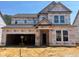 New home under construction featuring a classic two-story design and an attached two-car garage at 776 Old Station Pointe, Angier, NC 27501