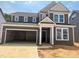 Two-story home showcasing a gray exterior, white trim, a two-car garage, and a well-defined roof line at 776 Old Station Pointe, Angier, NC 27501