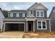 New two-story home featuring a two-car garage and classic design with gray siding and white trim at 776 Old Station Pointe, Angier, NC 27501