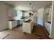 A kitchen featuring white cabinets, island, and pendant lights ready for customization to your preferences at 776 Old Station Pointe, Angier, NC 27501