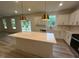 Kitchen featuring a central island with stone countertop, stainless steel appliances, and sleek cabinetry at 776 Old Station Pointe, Angier, NC 27501