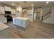 Kitchen with a center island, white cabinets and stainless steel appliances at 776 Old Station Pointe, Angier, NC 27501