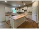 Unfinished kitchen featuring white cabinets, an island, and modern lighting fixtures at 776 Old Station Pointe, Angier, NC 27501